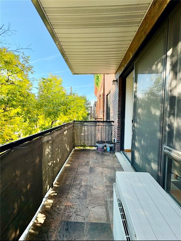 229 55th Street, Unit 3A Brooklyn, NY 11220 - Photo 8 of 10 a view of a balcony with floor to ceiling windows and wooden floor