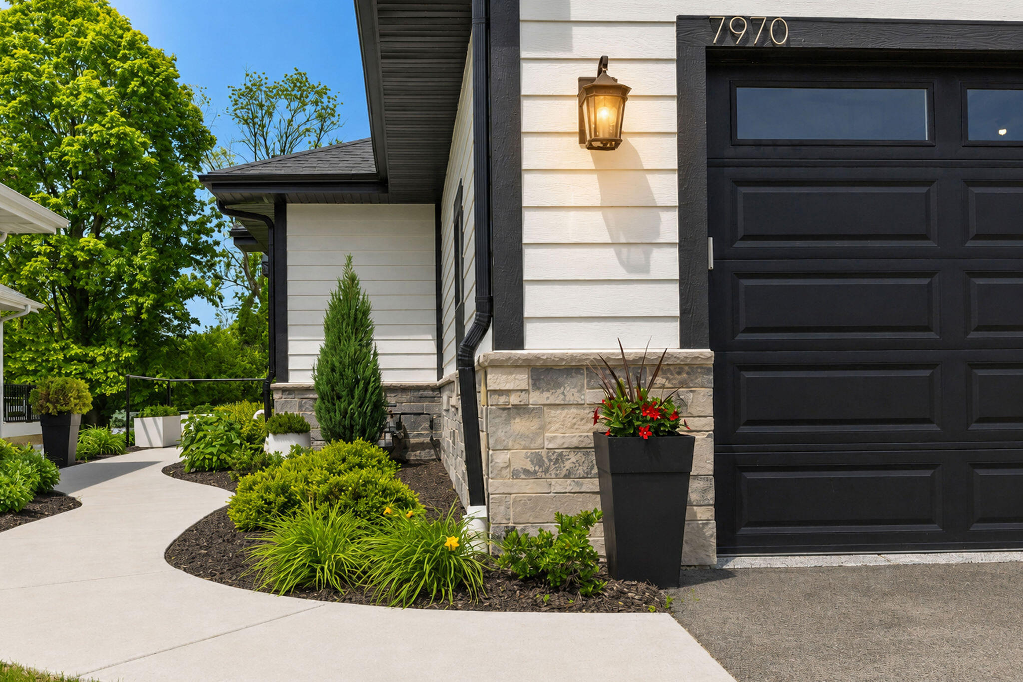 7970 West Stone Rdg Drive, Unit 851 Lannon, WI 53046 - Photo 40 of 49 Beautiful winding path with gorgeous landscaping and greenery.
