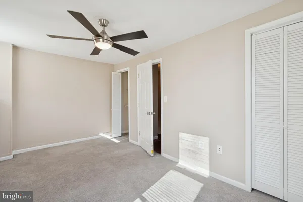a view of a livingroom with a ceiling fan and window