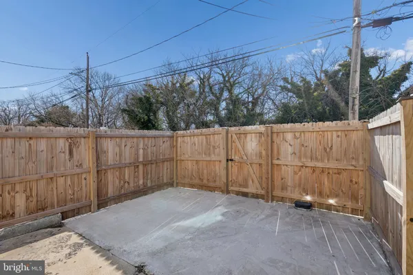 a view of a backyard with wooden fence