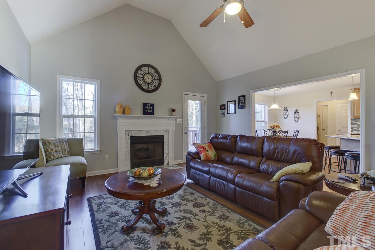 247 Cross Ridge Drive Willow Spring, NC 27592 - Photo 1 of 25 a living room with furniture a fireplace and a large window
