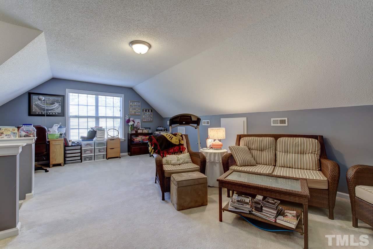 247 Cross Ridge Drive Willow Spring, NC 27592 - Photo 22 of 25 a living room with furniture and a window