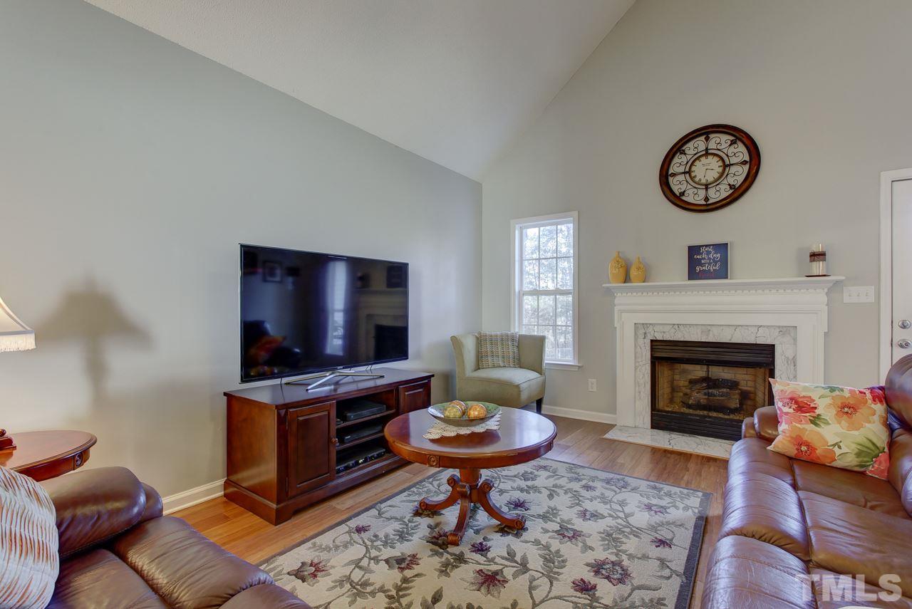 247 Cross Ridge Drive Willow Spring, NC 27592 - Photo 4 of 25 a living room with furniture a rug and a fireplace