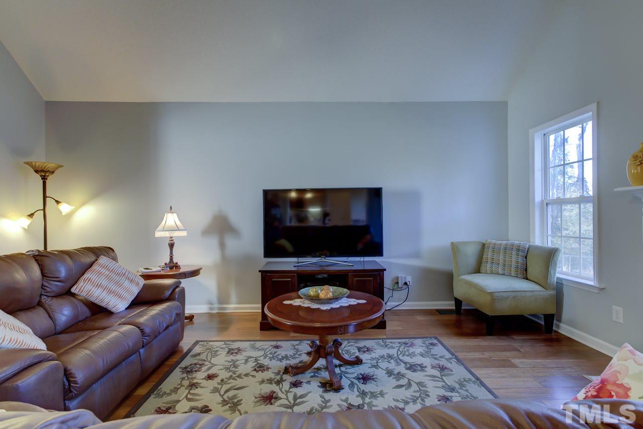 247 Cross Ridge Drive Willow Spring, NC 27592 - Photo 5 of 25 a living room with furniture and a flat screen tv