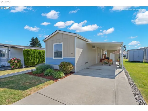 a view of a house with backyard and sitting area