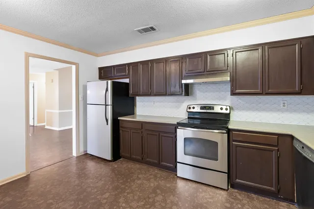 a kitchen with a refrigerator sink and cabinets