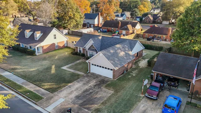 an aerial view of a houses with yard