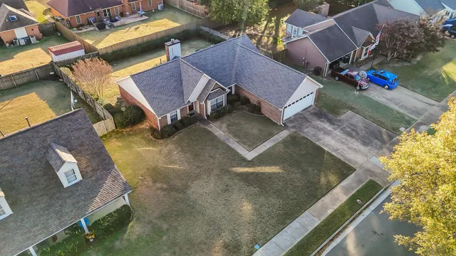 an aerial view of a house with a yard