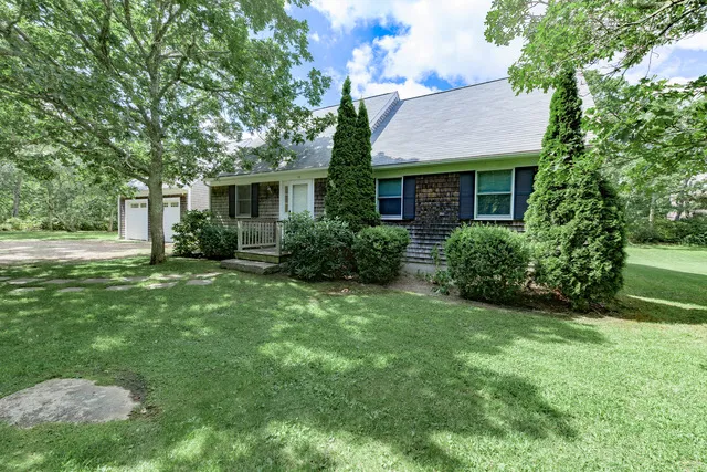 a front view of house with yard and green space
