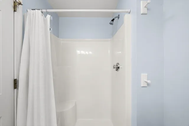 a bathroom with a shower curtain and a shower curtain