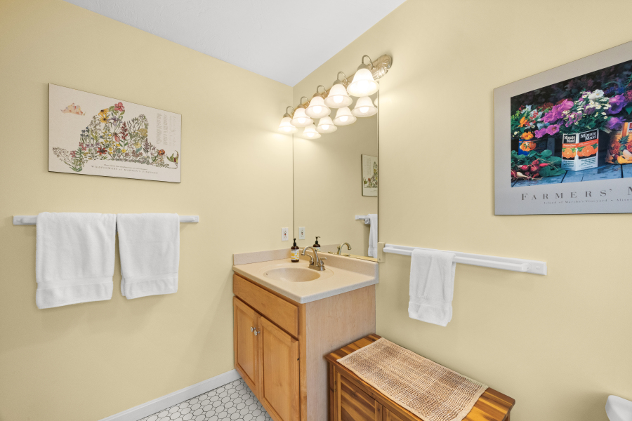 68 20th Street South Edgartown, MA 02539 - Photo 21 of 26 a bathroom with a sink mirror and a picture of a bathroom