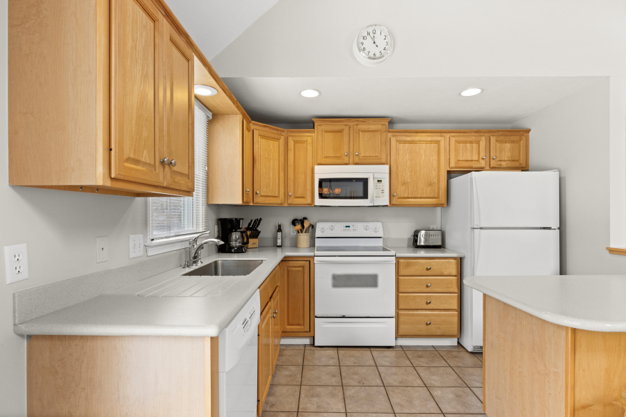 68 20th Street South Edgartown, MA 02539 - Photo 9 of 26 a kitchen with a sink a stove and refrigerator
