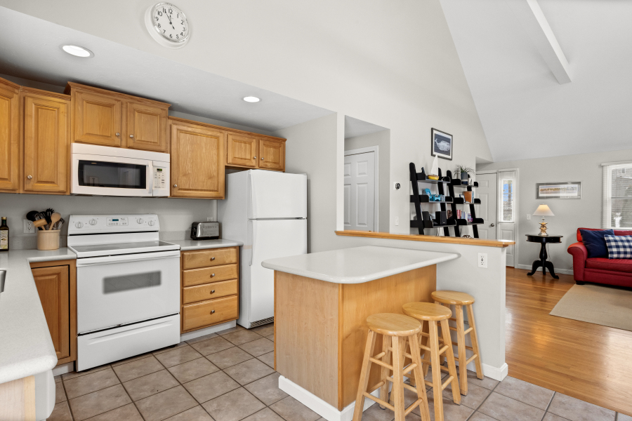 68 20th Street South Edgartown, MA 02539 - Photo 10 of 26 a kitchen with stainless steel appliances a stove refrigerator sink and cabinets