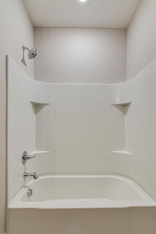 115 West Jones Street, Unit 201 Krum, TX 76249 - Photo 11 of 15 a bathroom with a bathtub