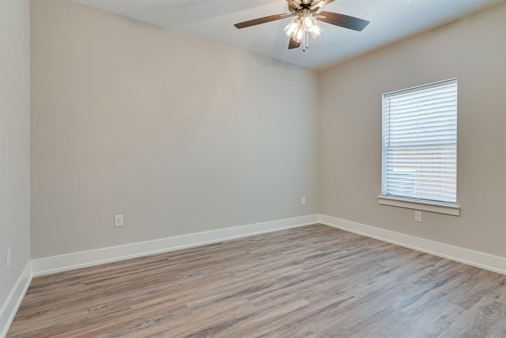 115 West Jones Street, Unit 201 Krum, TX 76249 - Photo 12 of 15 wooden floor in an empty room with a window
