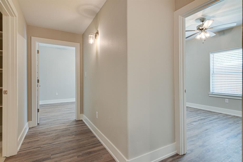 115 West Jones Street, Unit 201 Krum, TX 76249 - Photo 7 of 15 a view of a hallway with wooden floor
