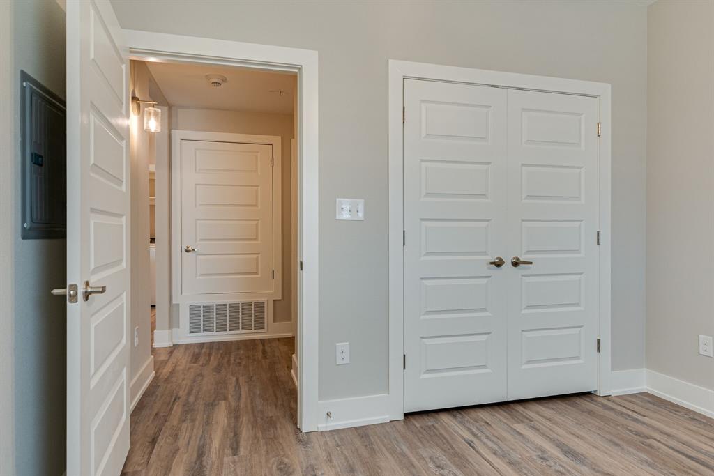 115 West Jones Street, Unit 201 Krum, TX 76249 - Photo 9 of 15 wooden floor with white walls