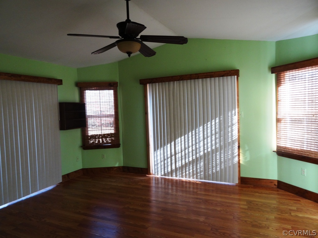 19225 Templeton Road Carson, VA 23830 - Photo 13 of 21 an empty room with wooden floor a ceiling fan and windows