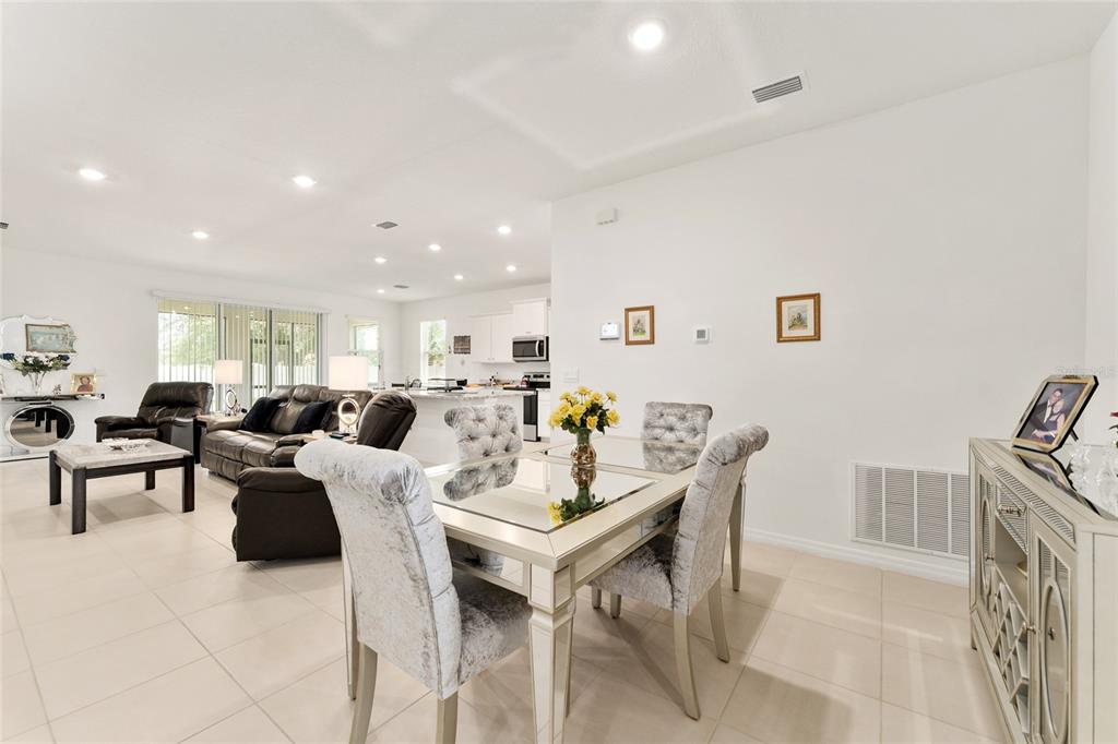 6175 Southwest 88th Loop Ocala, FL 34476 - Photo 13 of 56 a living room with lots of furniture and a wooden floor