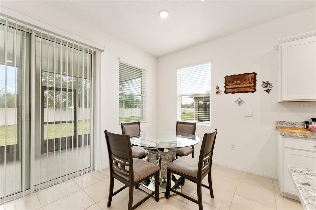 6175 Southwest 88th Loop Ocala, FL 34476 - Photo 22 of 56 a view of a dining room with furniture and a window