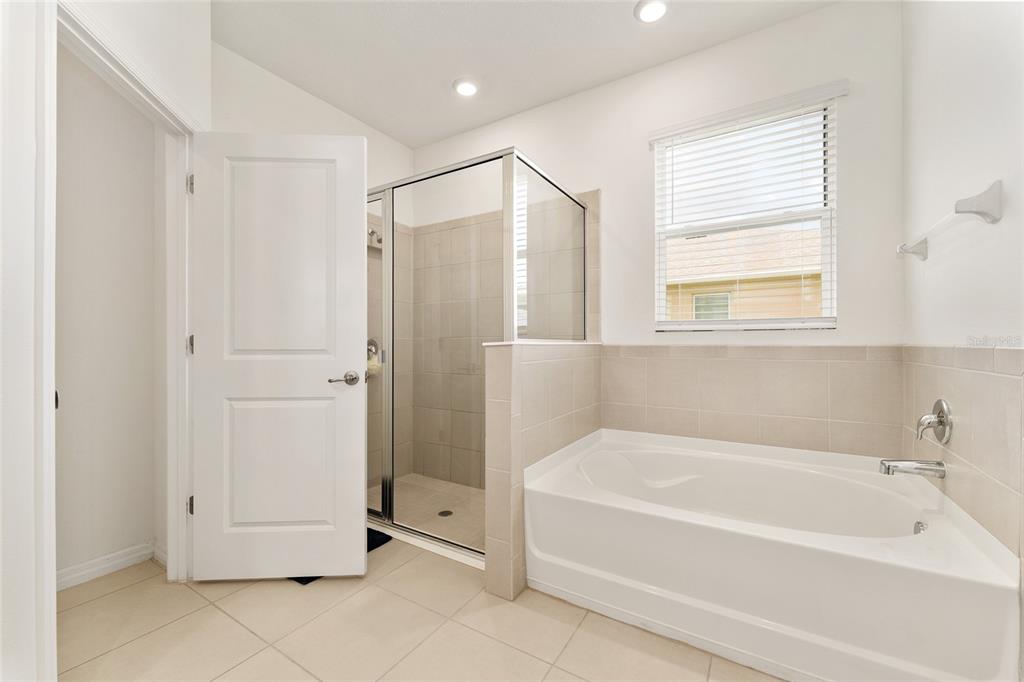 6175 Southwest 88th Loop Ocala, FL 34476 - Photo 32 of 56 a bathroom with a bathtub and a shower