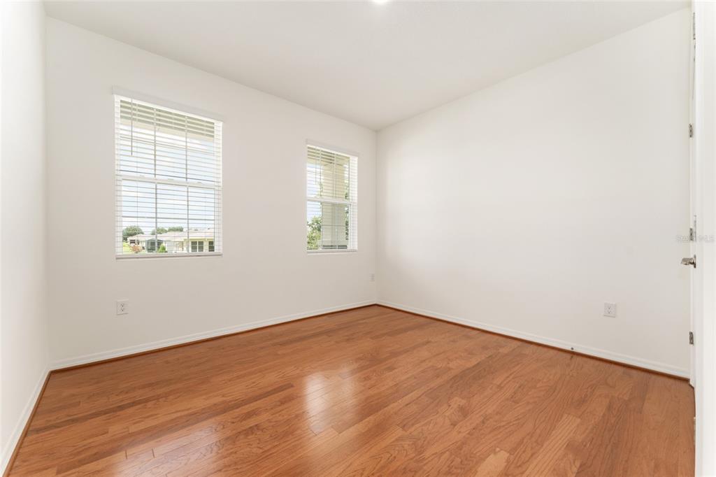 6175 Southwest 88th Loop Ocala, FL 34476 - Photo 40 of 56 an empty room with wooden floor and windows