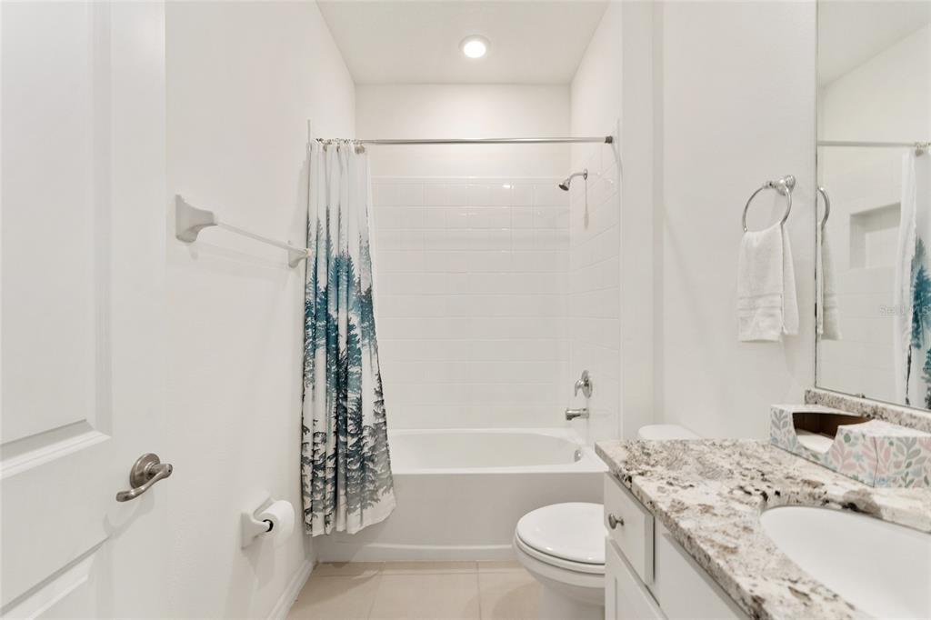 6175 Southwest 88th Loop Ocala, FL 34476 - Photo 41 of 56 a bathroom with a sink a toilet and shower