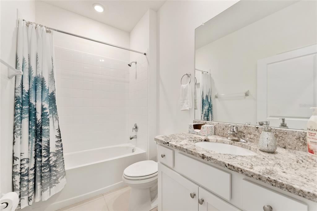 6175 Southwest 88th Loop Ocala, FL 34476 - Photo 42 of 56 a bathroom with a granite countertop sink toilet and shower