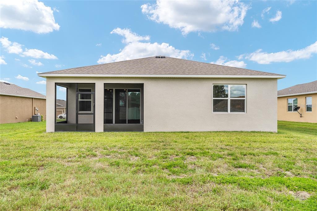 6175 Southwest 88th Loop Ocala, FL 34476 - Photo 50 of 56 a backyard of a house with table and chairs