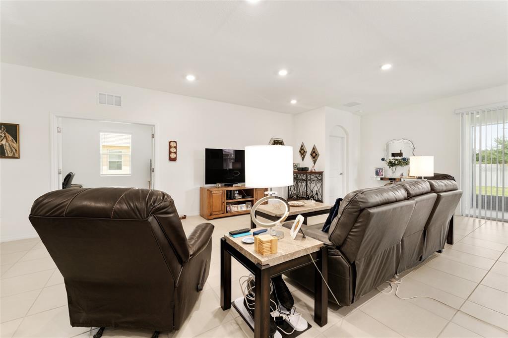 6175 Southwest 88th Loop Ocala, FL 34476 - Photo 5 of 56 a living room with furniture and a flat screen tv