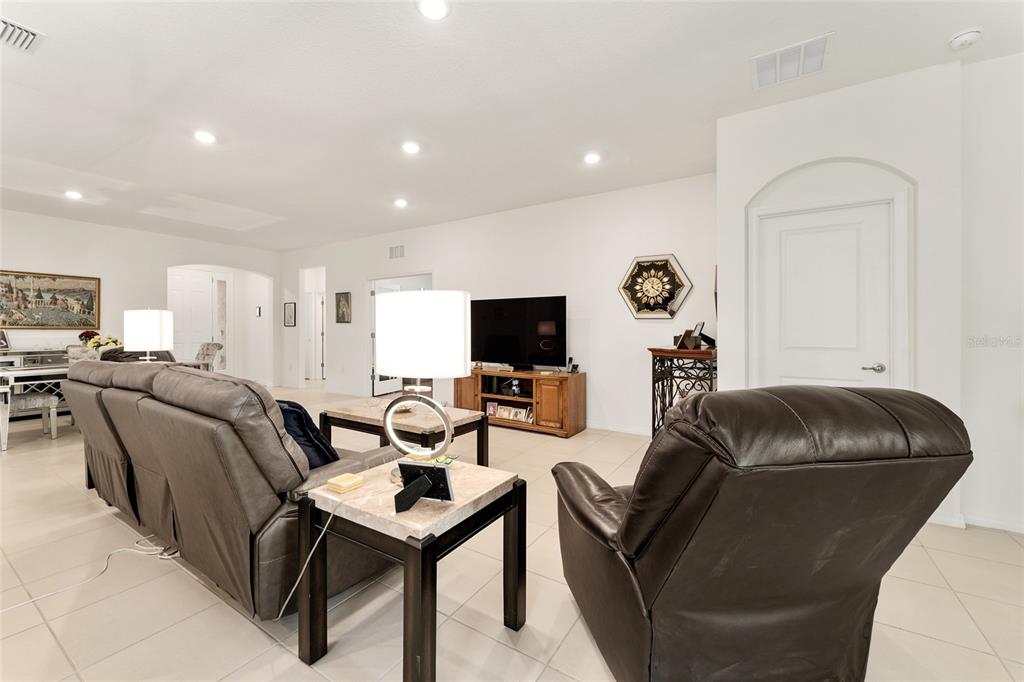 6175 Southwest 88th Loop Ocala, FL 34476 - Photo 6 of 56 a living room with furniture and a flat screen tv
