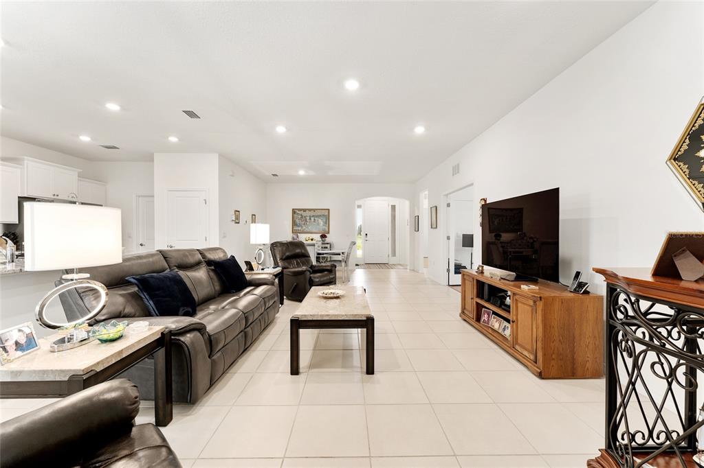 6175 Southwest 88th Loop Ocala, FL 34476 - Photo 7 of 56 a living room with furniture and a flat screen tv