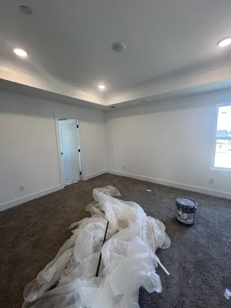 a bed sitting in a room next to a window