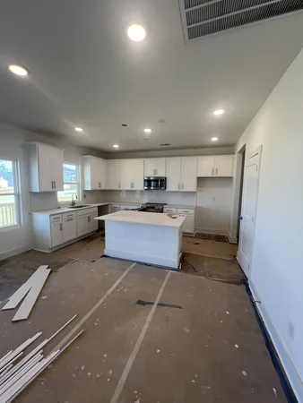 a kitchen with a refrigerator a sink and cabinets