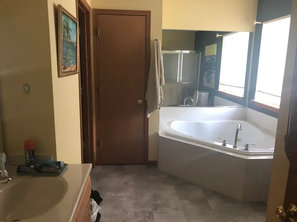 a bath tub sitting in a bathroom next to a sink