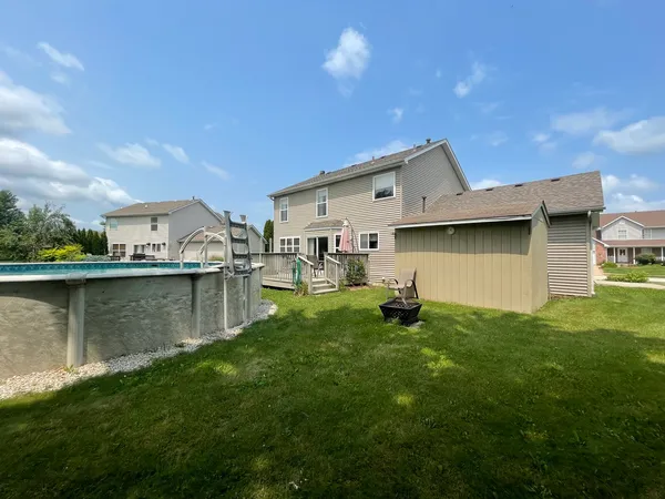 a swimming pool with outdoor seating and yard