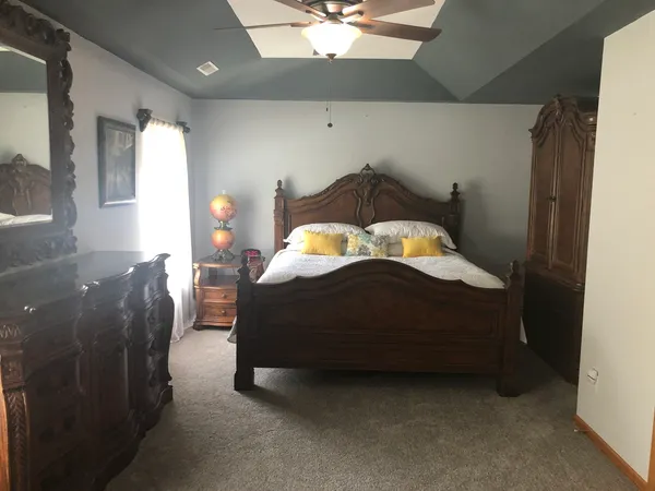 a bedroom with a bed and a chandelier