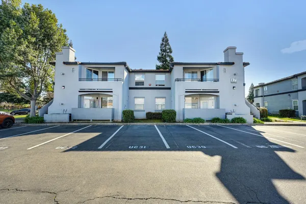a front view of a building with a yard