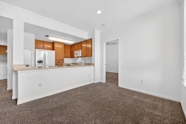 a kitchen with stainless steel appliances granite countertop a sink a stove and a refrigerator