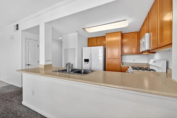 a kitchen with a refrigerator stove and microwave
