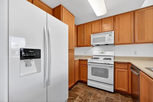 a kitchen with stainless steel appliances granite countertop a sink and a window