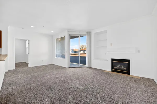 a view of an empty room with a fireplace
