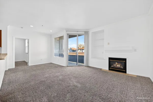 a view of a big room with wooden floor and cabinet