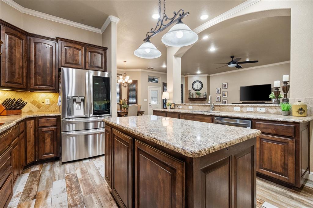 a kitchen with stainless steel appliances granite countertop a sink stove and refrigerator