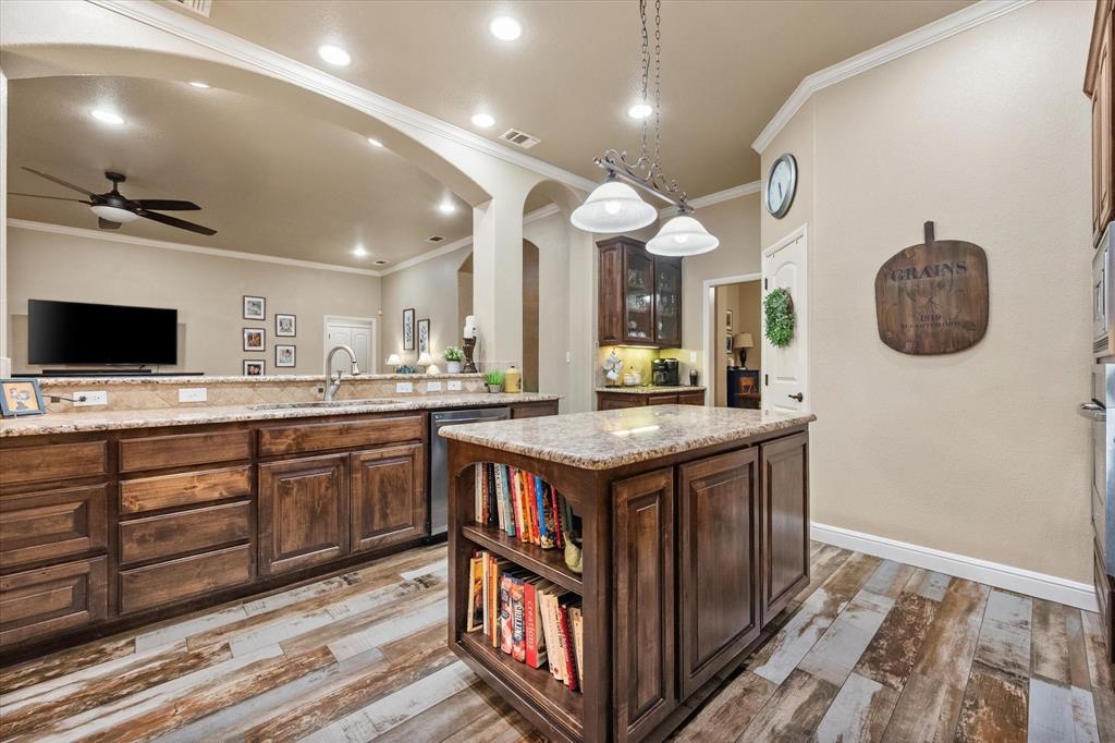 3715 Lonesome Creek Road Granbury, TX 76049 - Photo 17 of 40 a kitchen with a stove cabinets and wooden floor