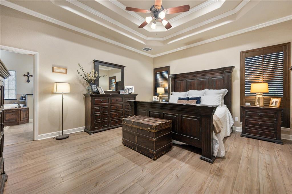 3715 Lonesome Creek Road Granbury, TX 76049 - Photo 23 of 40 a bedroom with a bed and wooden floor