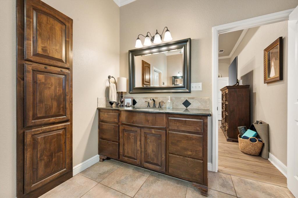 3715 Lonesome Creek Road Granbury, TX 76049 - Photo 27 of 40 a bathroom with a sink a mirror and a refrigerator