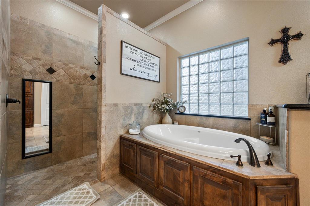 3715 Lonesome Creek Road Granbury, TX 76049 - Photo 28 of 40 a bathroom with a tub a sink and a shower