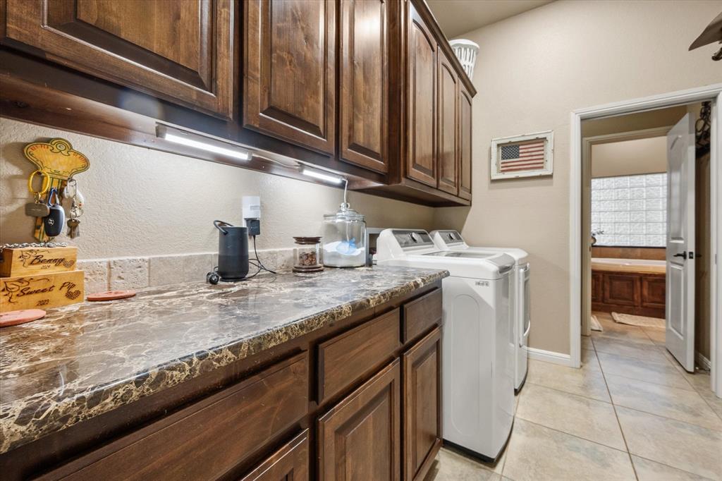 3715 Lonesome Creek Road Granbury, TX 76049 - Photo 29 of 40 a kitchen with granite countertop a sink a stove and cabinets