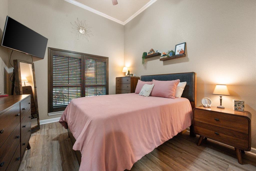 3715 Lonesome Creek Road Granbury, TX 76049 - Photo 30 of 40 a bedroom with a bed and a flat tv screen on dresser